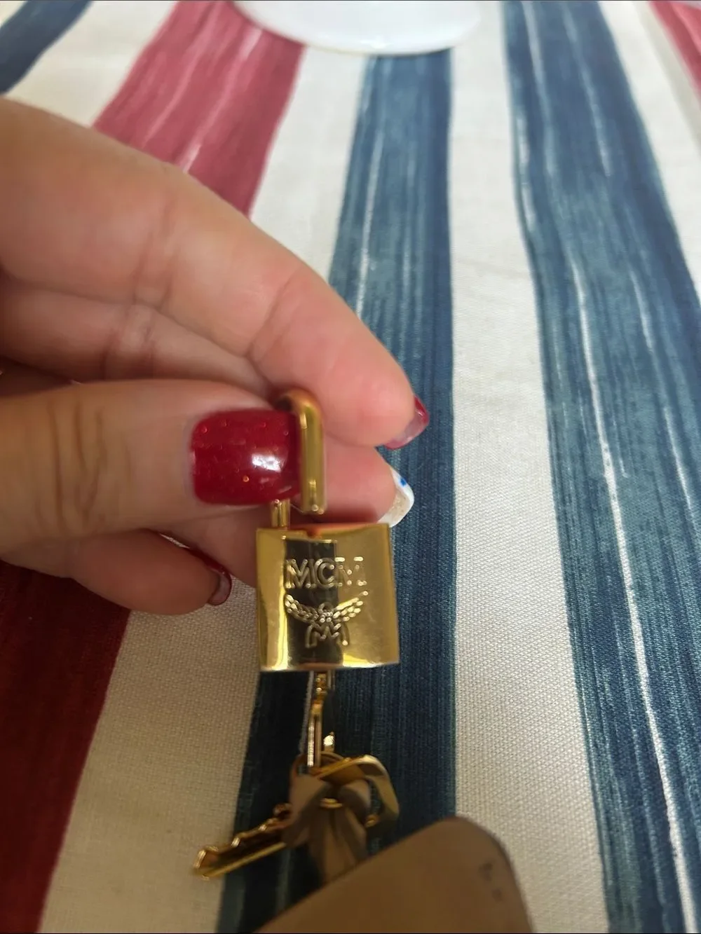 MCM jet and lock gold color with cream lanyard amazing condition